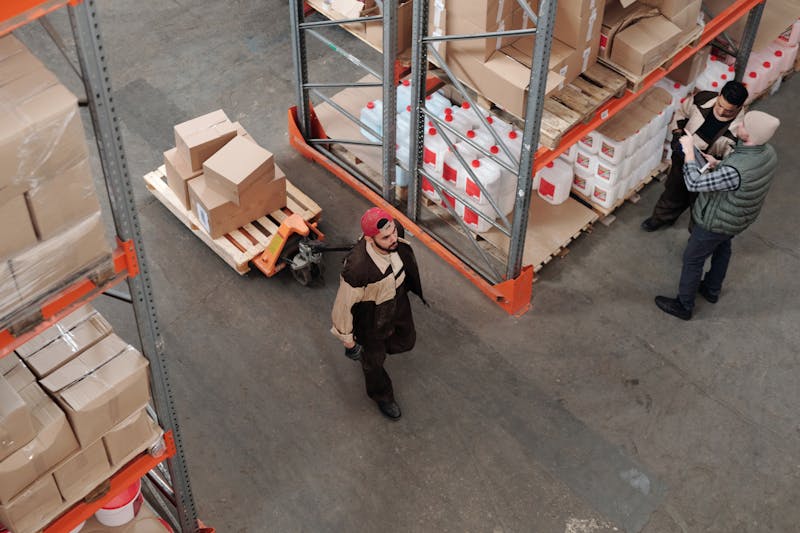 Warehouse workers moving pallets and boxes